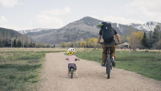 Father wearing Black Diamond Street Creek 24 biking with child