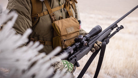 Western hunter holding rifle topped by the Maven RS1.2